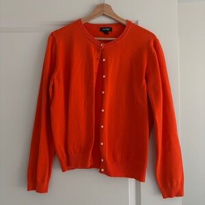 Red cardigan with pearl-effect buttons